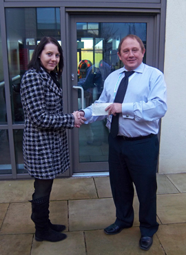 Charlie Middleton handing over a cheque to Steve Oliver at teh TCT Unit, Castle Hill hospital